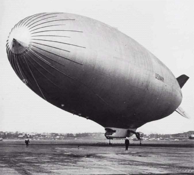 U.S. Navy ZPG-3W airship — large helium-filled non-rigid airship operated by the U.S. Navy at Naval Air Station Lakehurst, New Jersey for early-warning radar duty, shown at ground handling on the airfield with U.S. Navy markings on the envelope