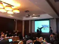 Critical Design Review presentation in progress at the C919 Spoiler CDR meeting — engineer presenting structural analysis slide to seated delegates in conference room