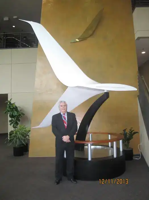 Steve Clamp standing in front of the Blended Split Winglet (Future Development Program) display sculpture in Aviation Partners Boeing / FACC lobby, 12 November 2013