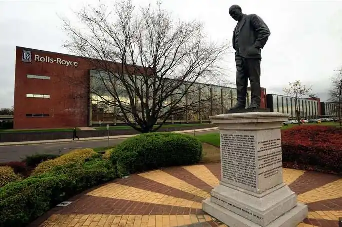 Sir Henry Royce statue (sculpted by Francis Derwent Wood) at the Rolls-Royce headquarters in Derby, with the Rolls-Royce Sinfin facility behind. Henry Royce, co-founder of Rolls-Royce, was the self-taught engineer behind the Silver Ghost car and the Merlin aero engine.
