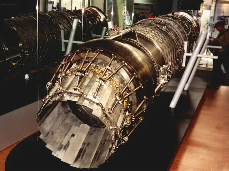 Eurojet EJ200 military low-bypass turbofan engine on display — bare engine showing afterburner section, exhaust nozzle assembly and turbine casing instrumentation