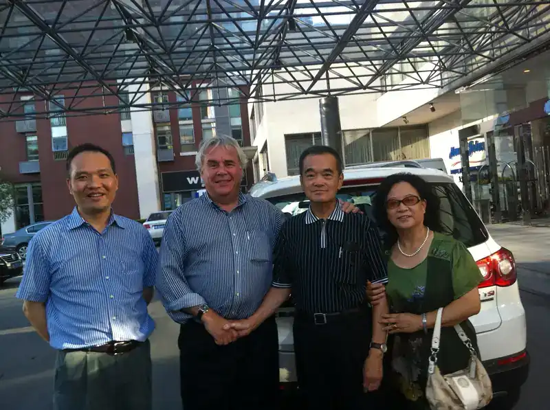 Steve Clamp and Michael C. Y. Niu (author of Airframe Stress Analysis and Sizing) with colleagues in Shanghai during the COMAC C919 development phase — taken at a Howard Johnson hotel entrance