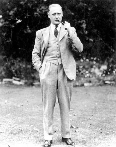 Aviation engineer of the 1930s standing in a three-piece suit