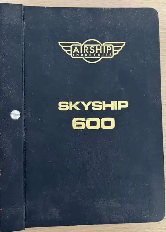 Airship Industries Skyship 600 original flight manual cover — black leather bound with gold Airship Industries logo and SKYSHIP 600 lettering