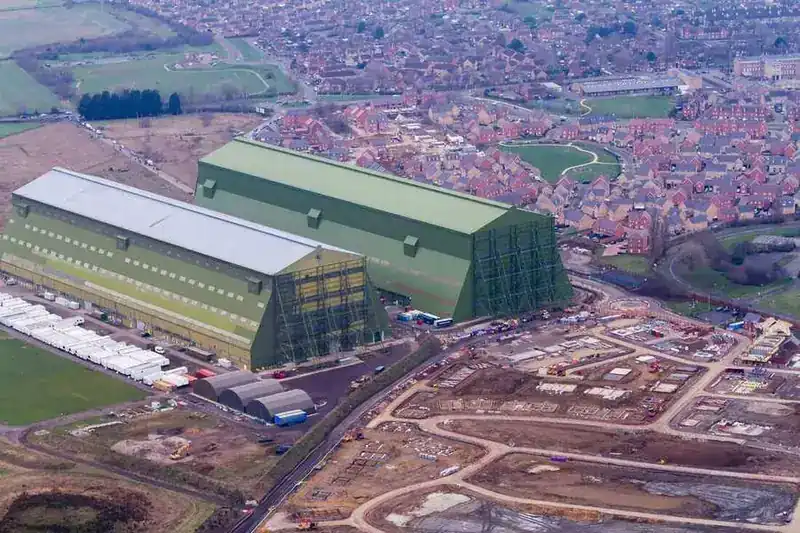 Aerial view of the Cardington Airship Sheds — massive green hangar where the Skyship 600 and other historic airships were built and housed