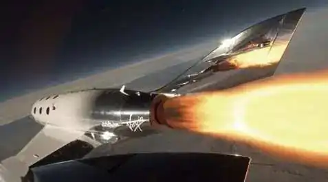 SpaceShipTwo hybrid rocket motor firing in flight — view of vehicle on ascent at edge of space