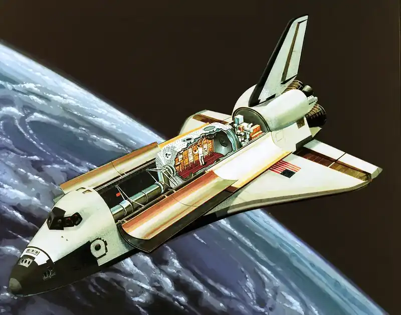 NASA artist concept of Spacelab integrated in the Space Shuttle payload bay — cutaway showing the pressurised laboratory module with experiment racks, attached pallet with cylindrical experiment hardware, and crew member at work inside the module. Earth visible below.