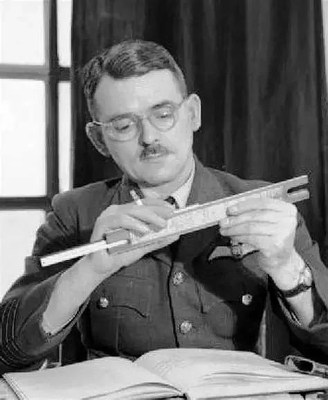 Sir Frank Whittle in RAF uniform working with a slide rule